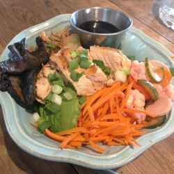 Salmon Teriyaki Poke Bowl with Jasmine Rice,  Avocado, Kimchee, Steamed Green Beans, Pickled Vegies, Portabella Mushrooms, Shredded Carrots, and Sliced Green Onions with Teriyaki Sauce